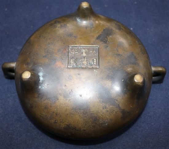 A Chinese brown patinated bronze ding censer, Xuande six character mark, probably 17th/18th century, width 21cm